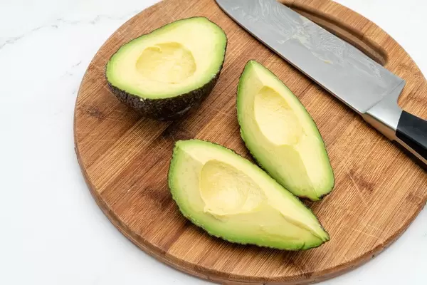 Top view of Sliced fresh Avocado with knife