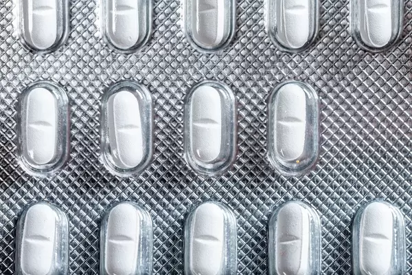 Top view of small white tablets in a package (Flip 2019)