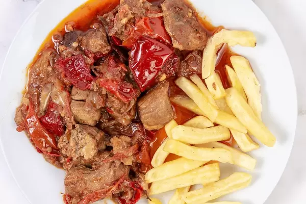 Top view of Traditinal meal Muckalica with Pork Meat and French Fries (Flip 2019)