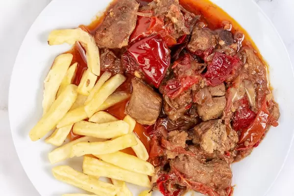 Top view of Traditinal meal Muckalica with Pork Meat and French Fries