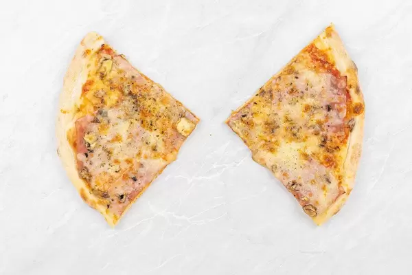 Top view of triangle Pizza slices above grey marble background table