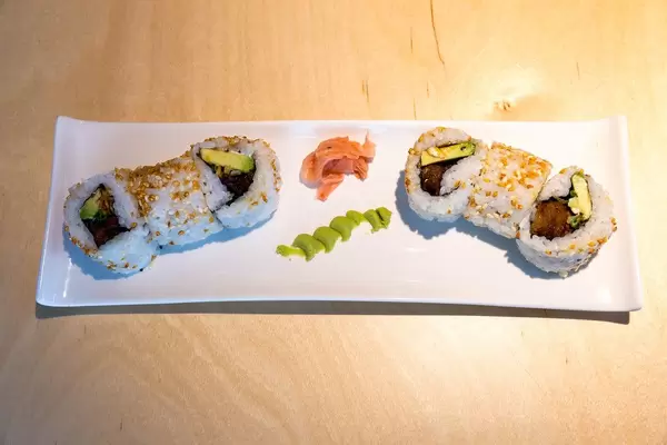 Top view of vegan sushi "Lucky No Meat" as meatless meal, with baked tofu, seitan, sweet sauce, kimchi sesame, vegan mayo and roasted onions