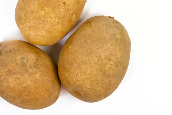Top view of Whole Potatoes isolated above white background (Flip 2019)