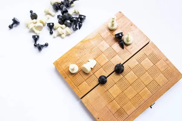 Top view of wooden chess box with figures on white background