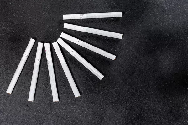 Top view on black cigarette background. The concept of addiction (Flip 2019)