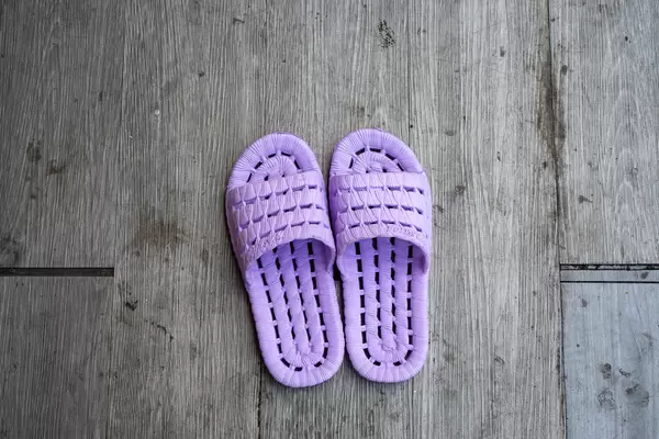 Top View Photo of Comfortable Purple Slippers for an Outdoor Rooftop Terrace at a Restaurant with Wooden Floor