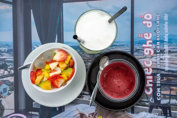 Top View Photo of Fruit Salad, Strawberry Yogurt and Avocado Ice Cream with Photo of Hotel Room as Background