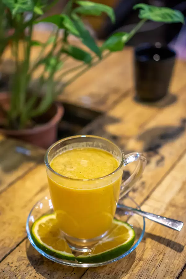 Top View Photo of Hot Orange Tea with Cinnamon and Orange Slices on a Wooden Table