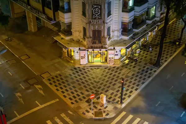 Top View Photo of Sushi Tei Restaurant with Empty Street and Sidewalk in the City Center in District 1 in Ho Chi Minh City, Vietnam