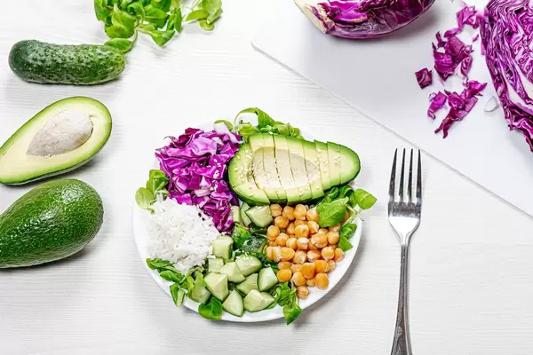 Top view plate with chickpeas, rice with chopped fresh vegetables (Flip 2019)