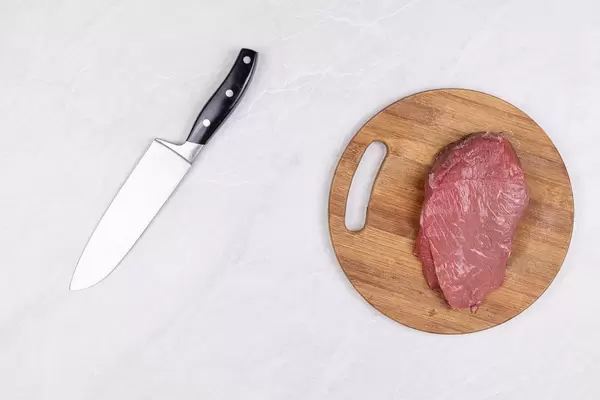 Top view Raw Beef Meat slice on the wooden board with knife
