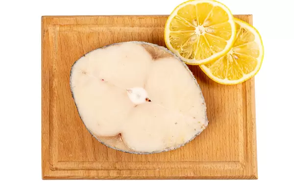 Top view, raw escolar fish steak on wooden board