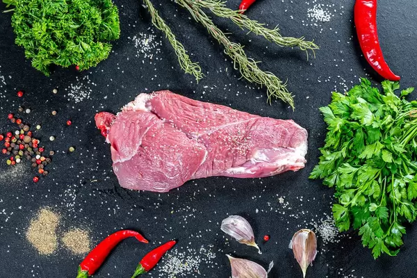 Top view raw pork with spices and herbs on black background (Flip 2019)
