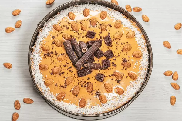 Top view ready homemade cake with condensed milk, chocolate and nuts