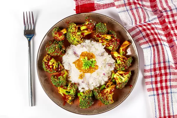 Top view, rice with broccoli in tomato sauce