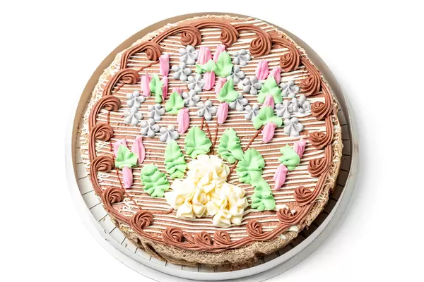 Top view, round cake with condensed milk, meringue and hazelnuts