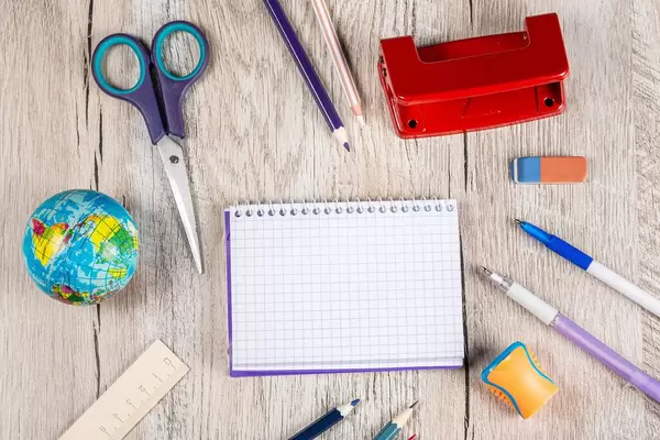 Top view, school things on a wooden background