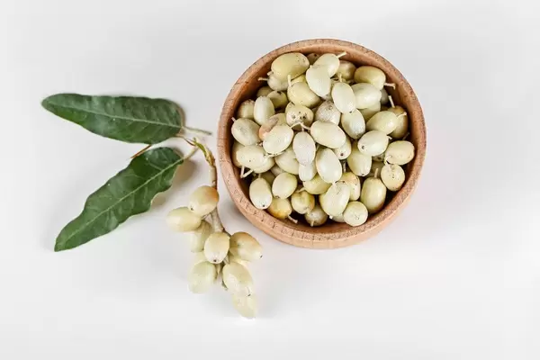 Top view, sea buckthorn berries in a wooden bowl on a white background
