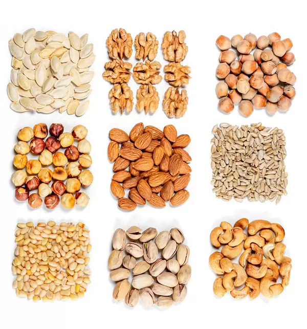 Top view, set of different types of nuts and seeds on a white background