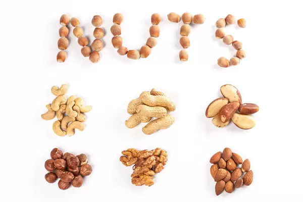 Top view, set of different types of nuts on a white background
