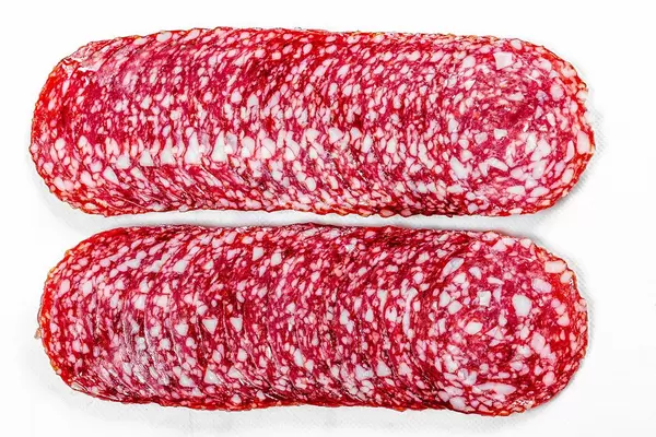 Top view sliced smoked salami on white background (Flip 2019)