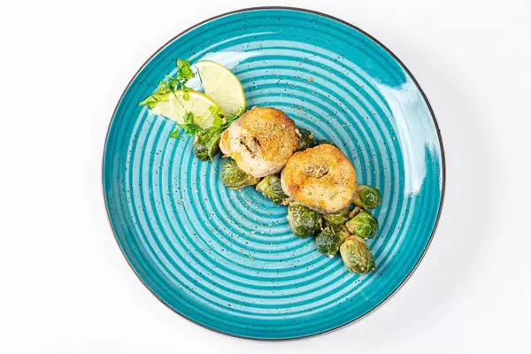 Top view slices of fried hake with Brussels sprouts (Flip 2019)