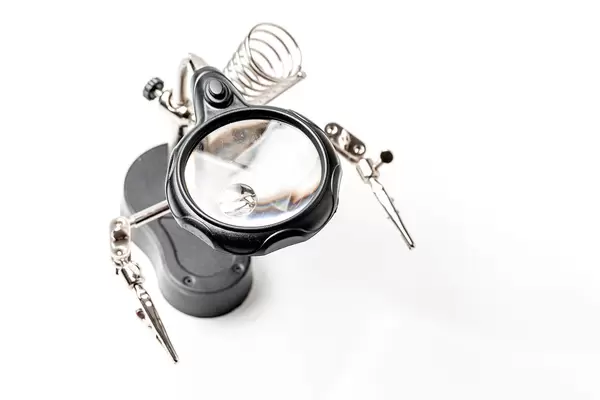 Top view, soldering iron stand with magnifying glass and clamps
