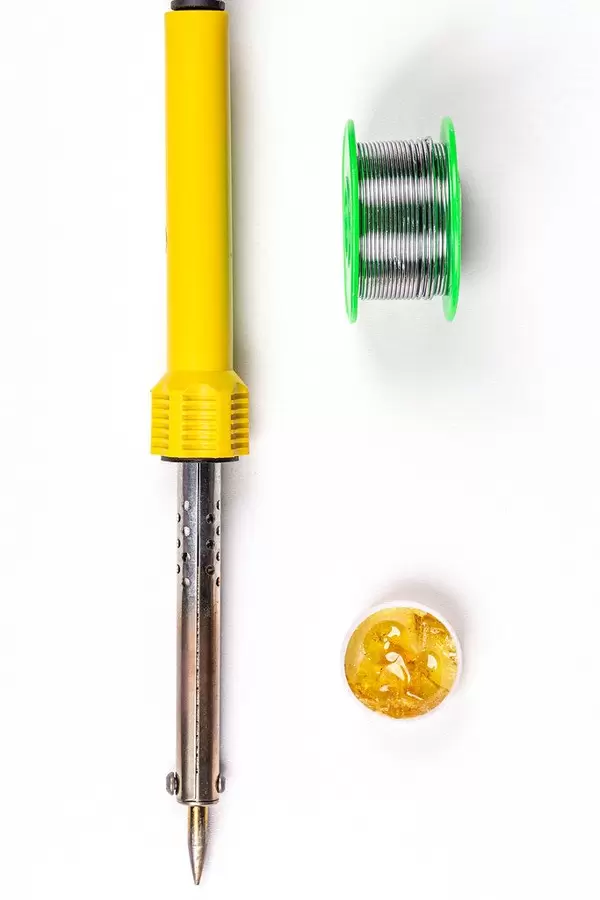 Top view, soldering iron, tin and rosin on white