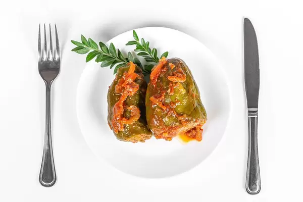 Top view, stuffed sweet peppers with tomato sauce