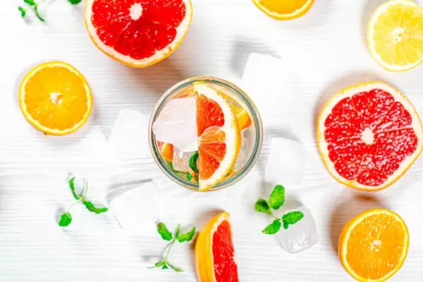 Top view, summer drink with ice cubes citrus slices and fresh mint