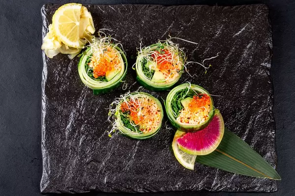 Top view sushi set with crab meat, red caviar, cucumber and micro greens (Flip 2019)