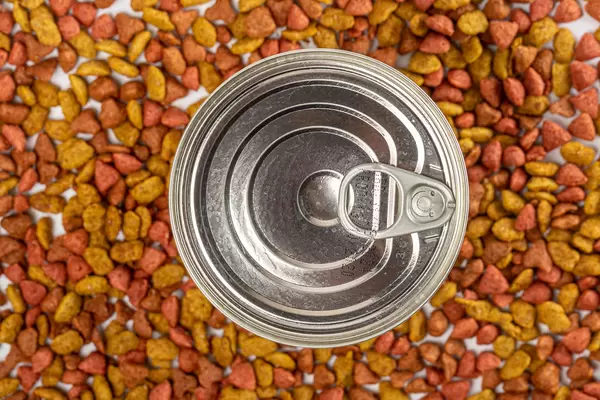 Top view, tinned food for pets on dry food background