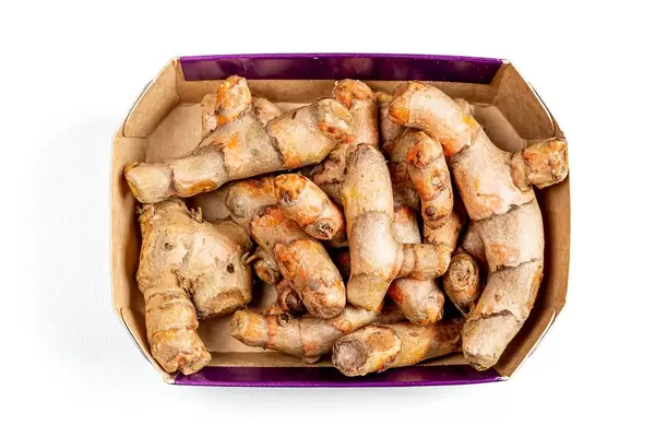 Top view, turmeric root in a box on a white background