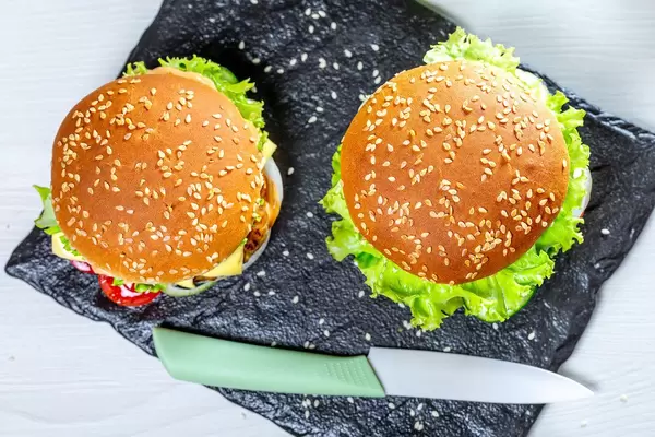 Top view, two homemade hamburgers with knife (Flip 2019)