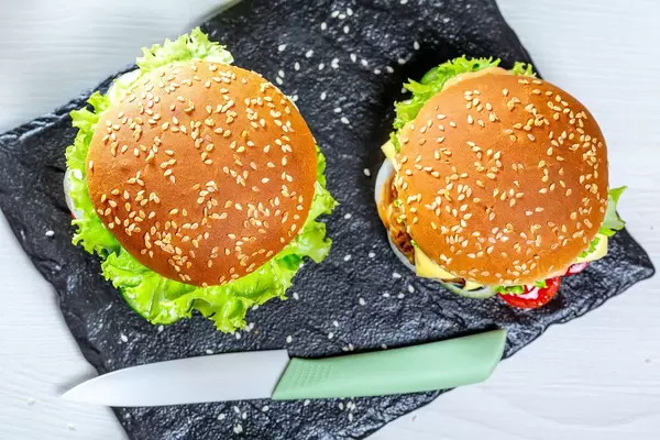 Top view, two homemade hamburgers with knife