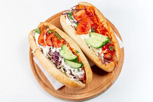 Top view, two hot dogs on a wooden kitchen board (Flip 2020)