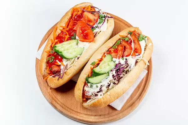Top view, two hot dogs on a wooden kitchen board