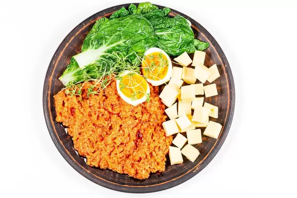 Top view, vegetables with egg and cheese on a plate