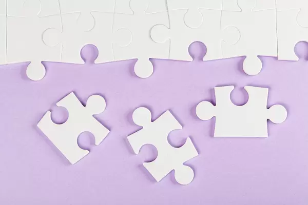Top view, white puzzles on purple background