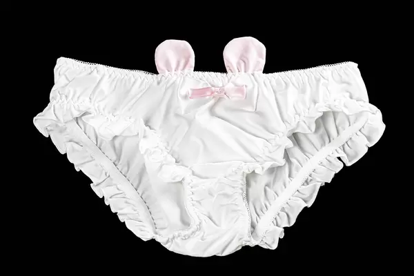 Top view, white women's panties with a bow and ears on black