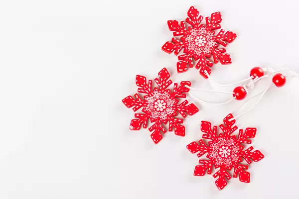 Top view, wooden snowflakes decor on white background