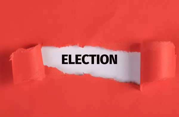 Torn paper revealing the word Election