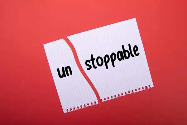 Torn paper with Unstoppable text on red background