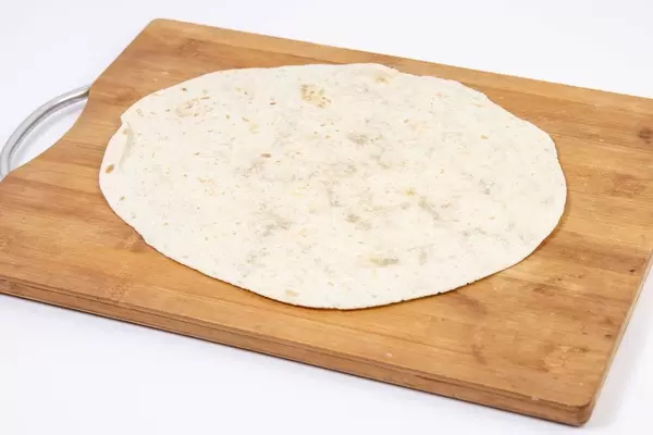 Tortilla on the wooden kitchen board (Flip 2019)