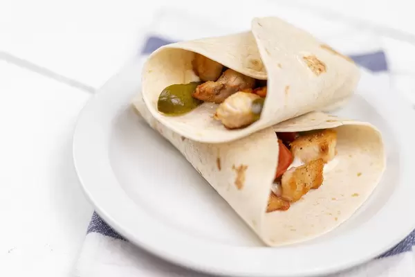 Tortillas with fried Chicken Meat and Vegetables served on the plate