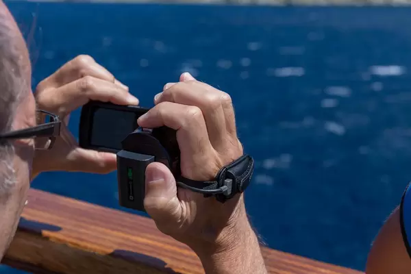 Tourist filming Greek monasteries with his camcorder