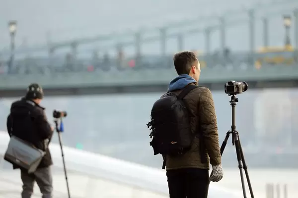 Tourists photographing Danube river in Budapest, Hungary