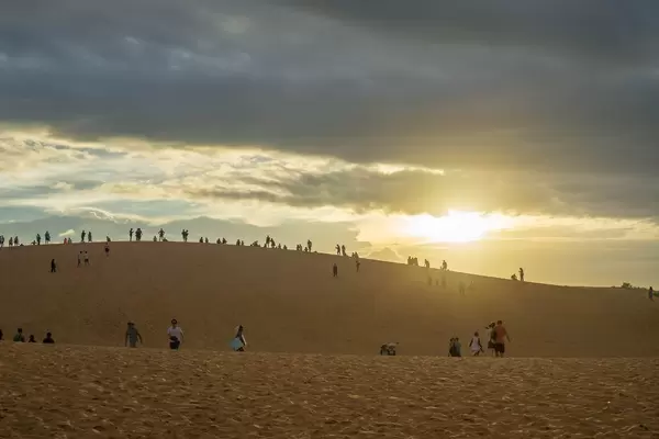 Tourists watching the Sunset in Red Sand Dunes in Mui Ne, Vietnam  Flip 2019