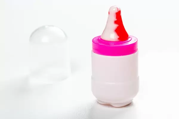 Toy baby bottle with a nipple-Lollipop on a white background (Flip 2019)