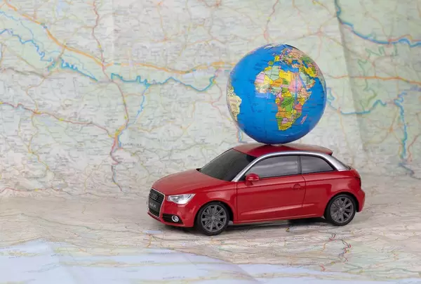 Toy car carrying a small globe